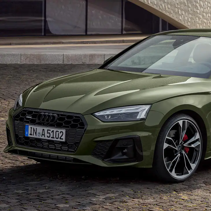 Green Audi A5 Coupe front angle parked