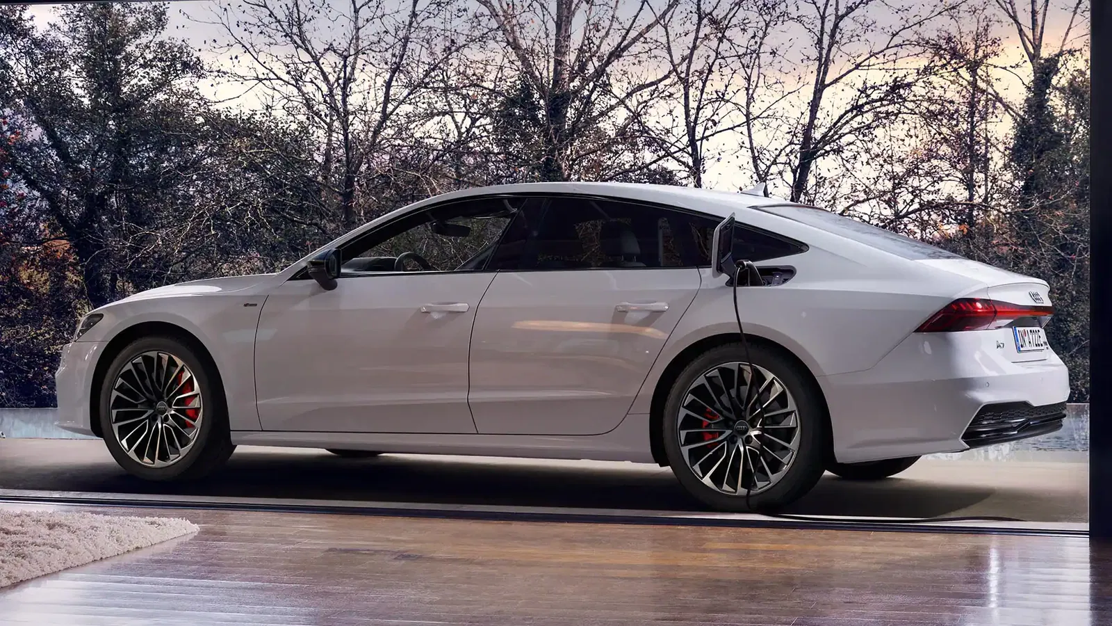 White Audi A7 Sportback TFSI e charging exterior rear