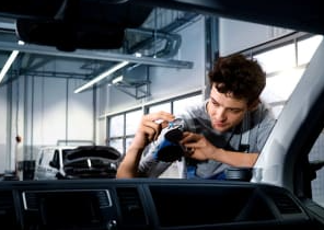 man checking windscreen