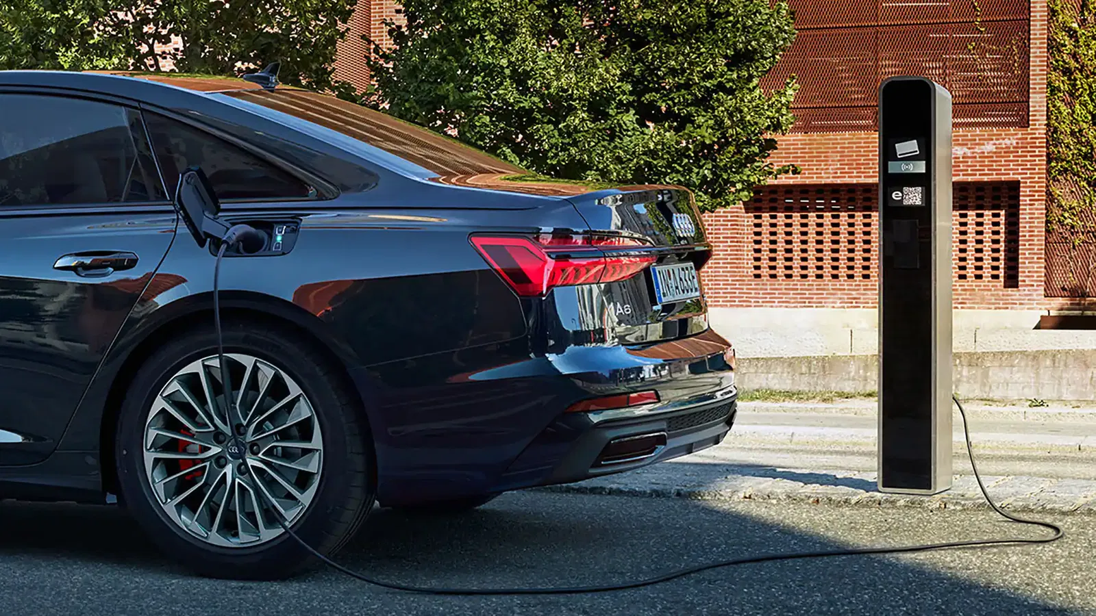 Audi A6 saloon tfsi e parked and charging