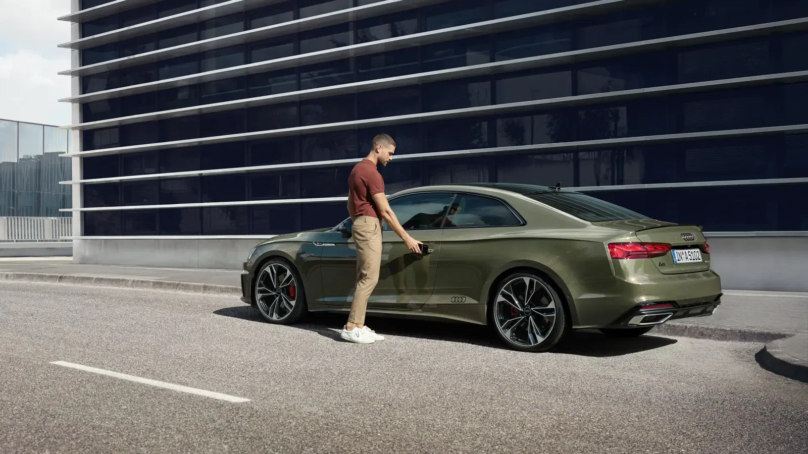Green Audi A5 Coupe rear angle parked