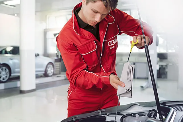 Audi technician working on the engine
