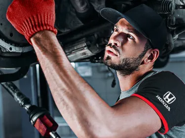 Honda Technician working under the car