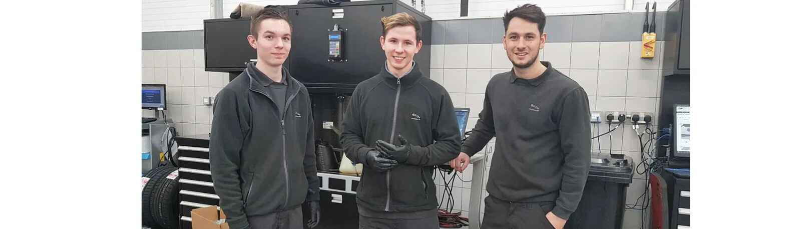 Workmen stood in Jaguar workshop