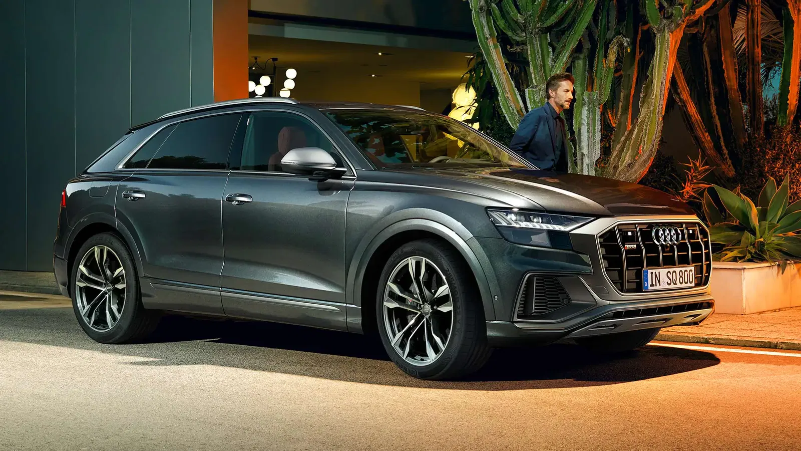 man walking behind audi sq8