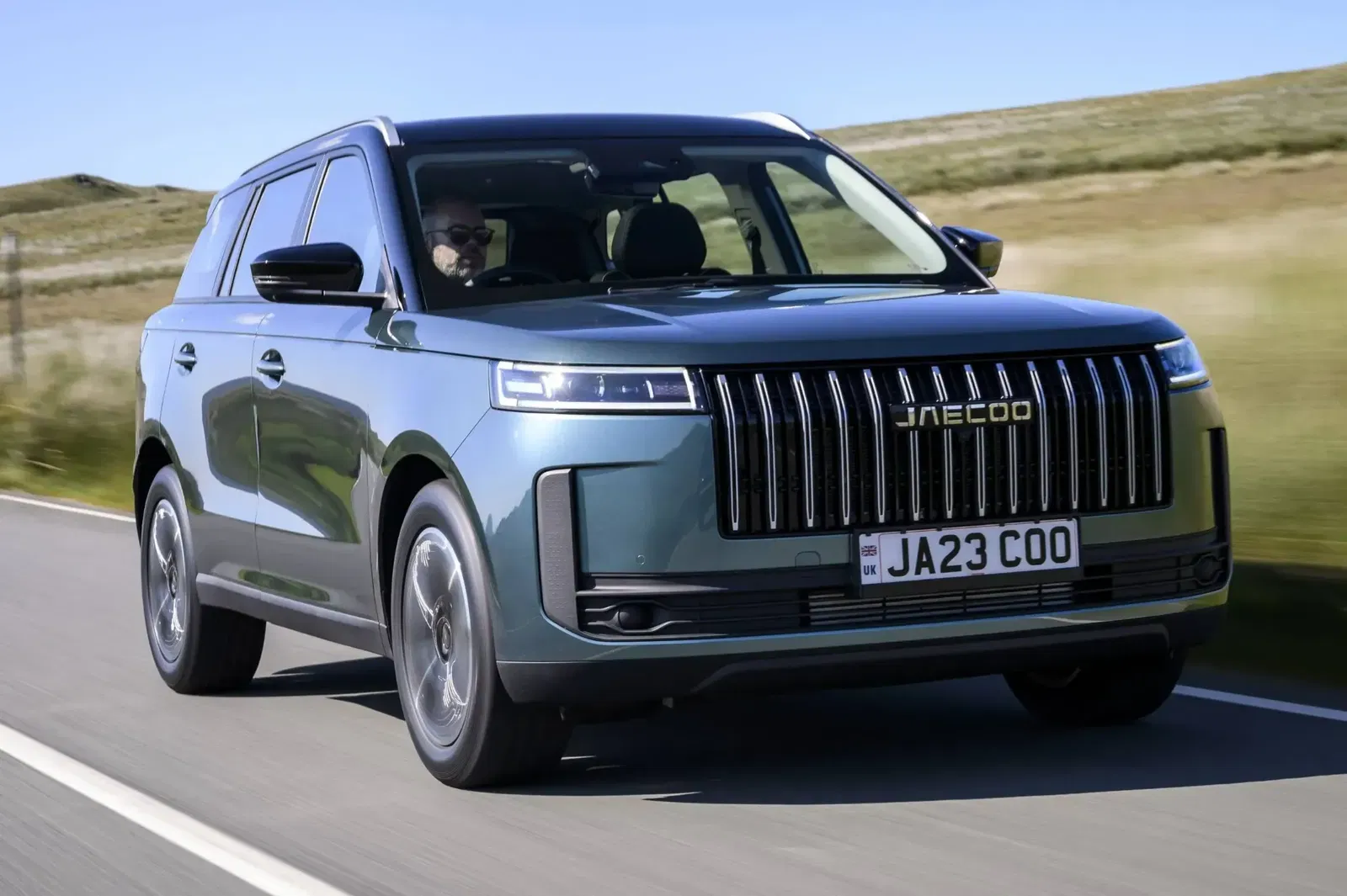 JAECOO Driving on road with fields in background