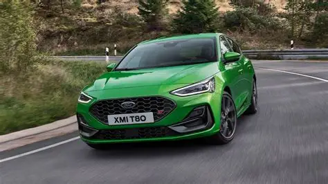 green ford focus st driving on road