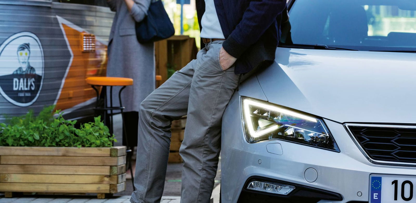 Man leaning against a SEAT car