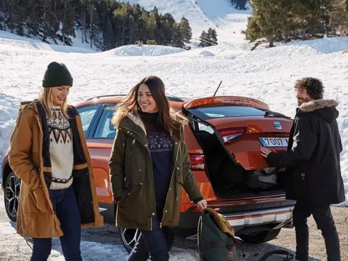 SEAT Ateca parked in snow with people walking