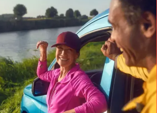 volkswagen caddy with couple in front of river