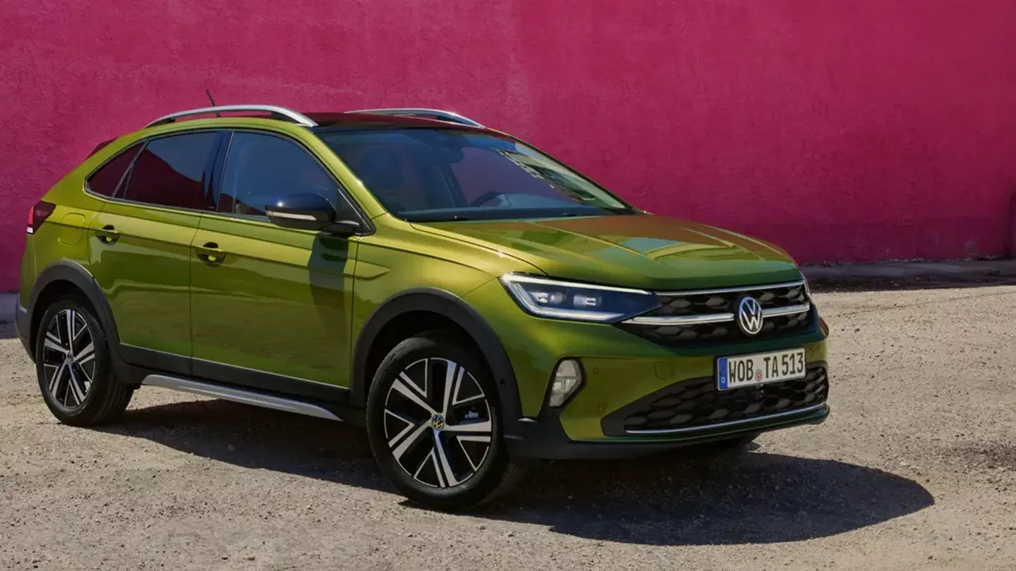 Green VW Taigo Parked Up in Front of Colourful Wall